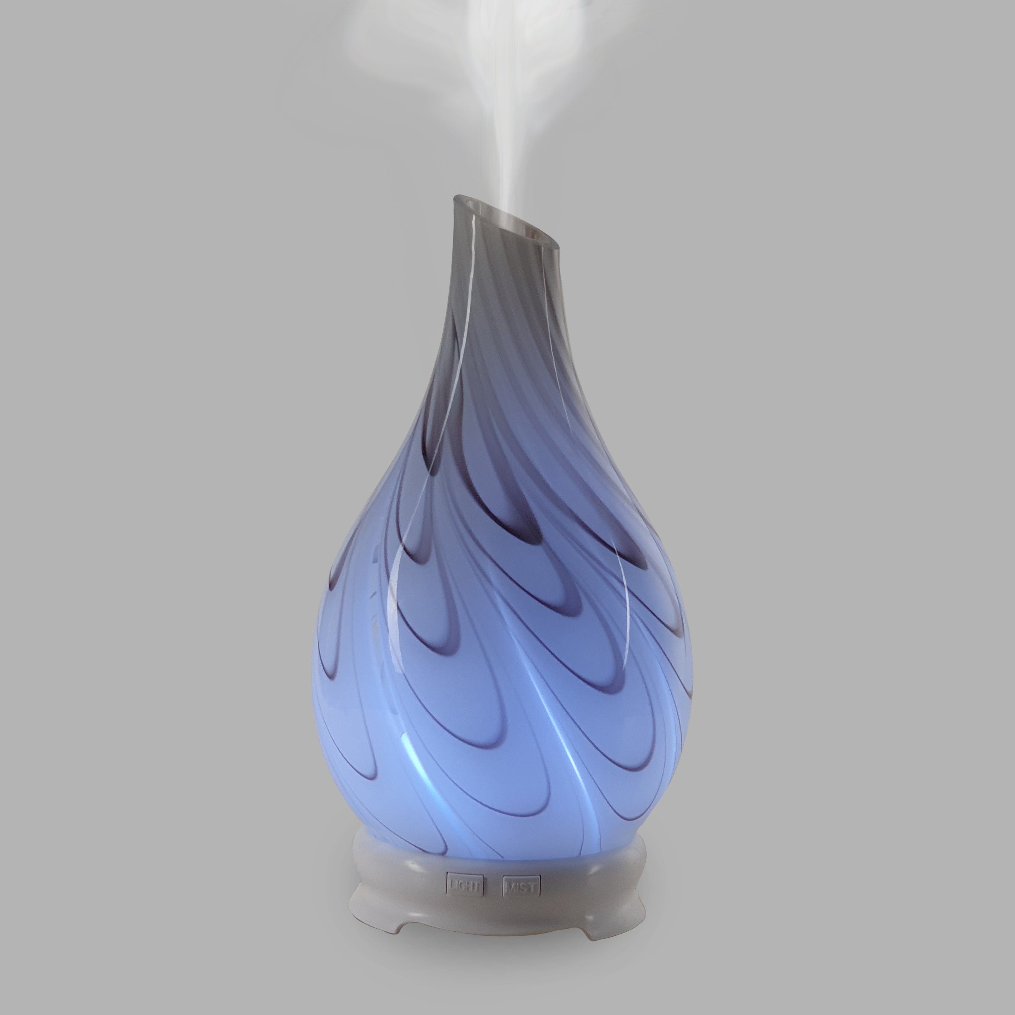 This Galaxy Swirl essential oil diffuser brings a modern look to any room with its swirling blend of red and brown.