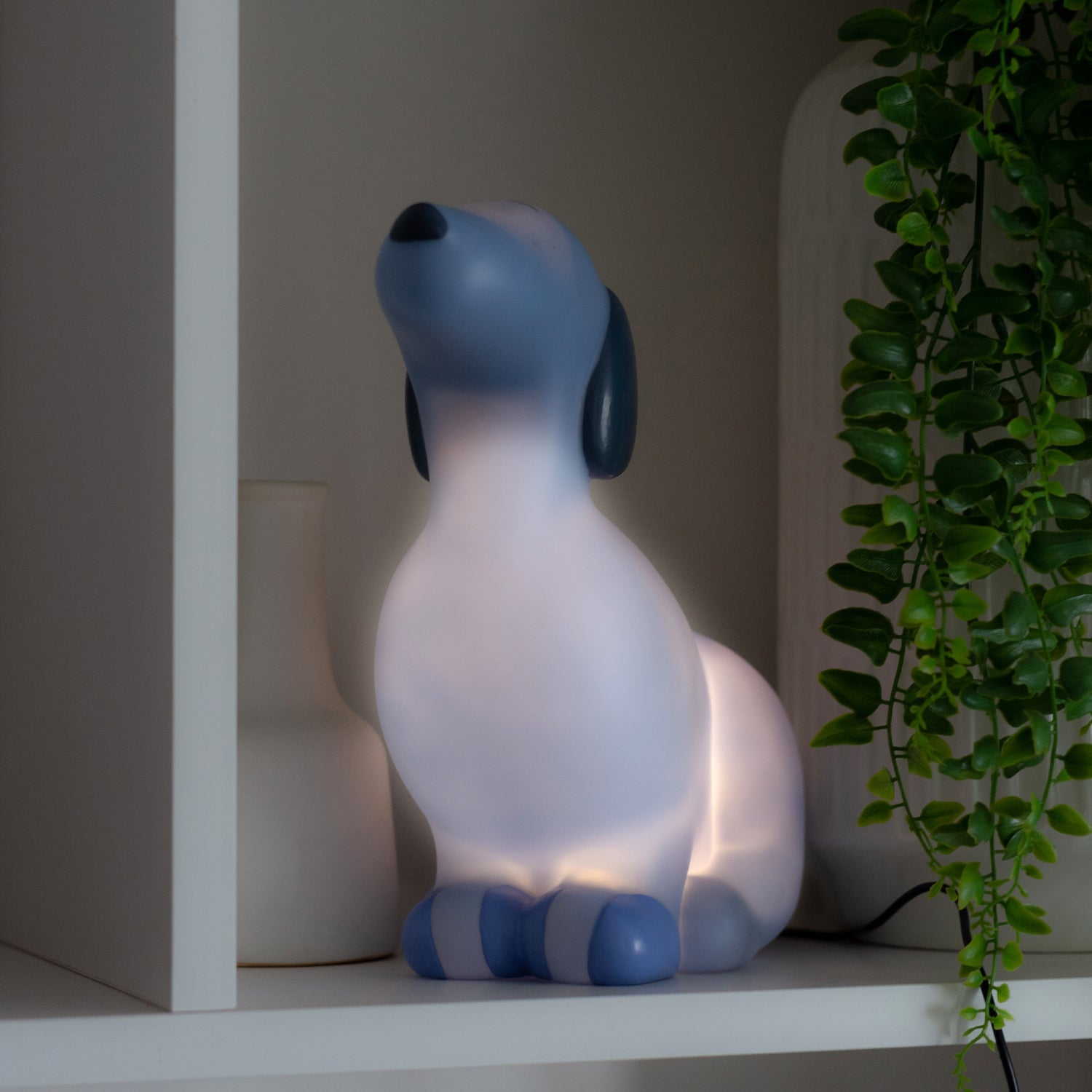 Standing Dog-shaped blue night light. These newest Night Lights are set to be an incredible décor addition to any little ones' room and an amazing gift idea for all occasions - birthdays, christenings, holidays, and just because! Boasting a collection of creatures that are sure to both delight and soothe kids of all ages, Night Lights come with custom packaging that features a fun poem and are powered by a USB cord to ensure the Night Light stays bright. 